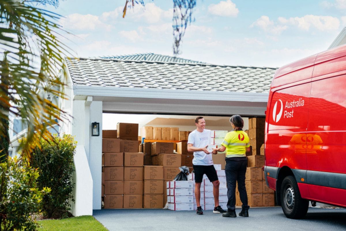 Australia Post courier delivering parcel to customer