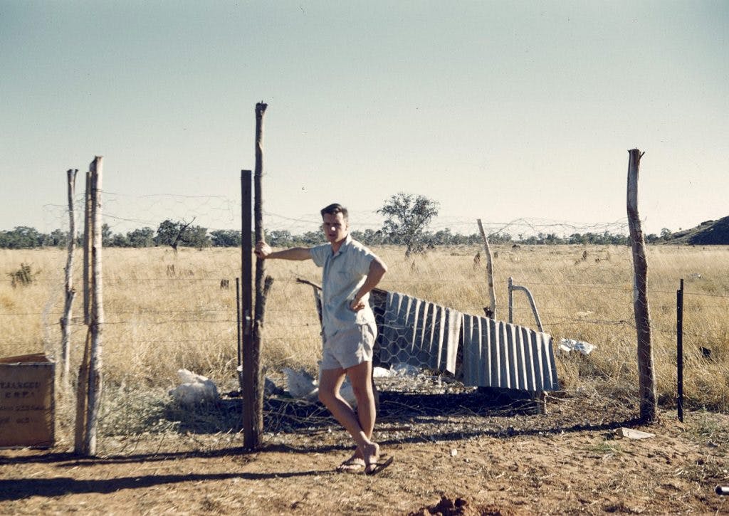 Gogo Station School, Brian Hassell standing in front of the chook pen, 1962.